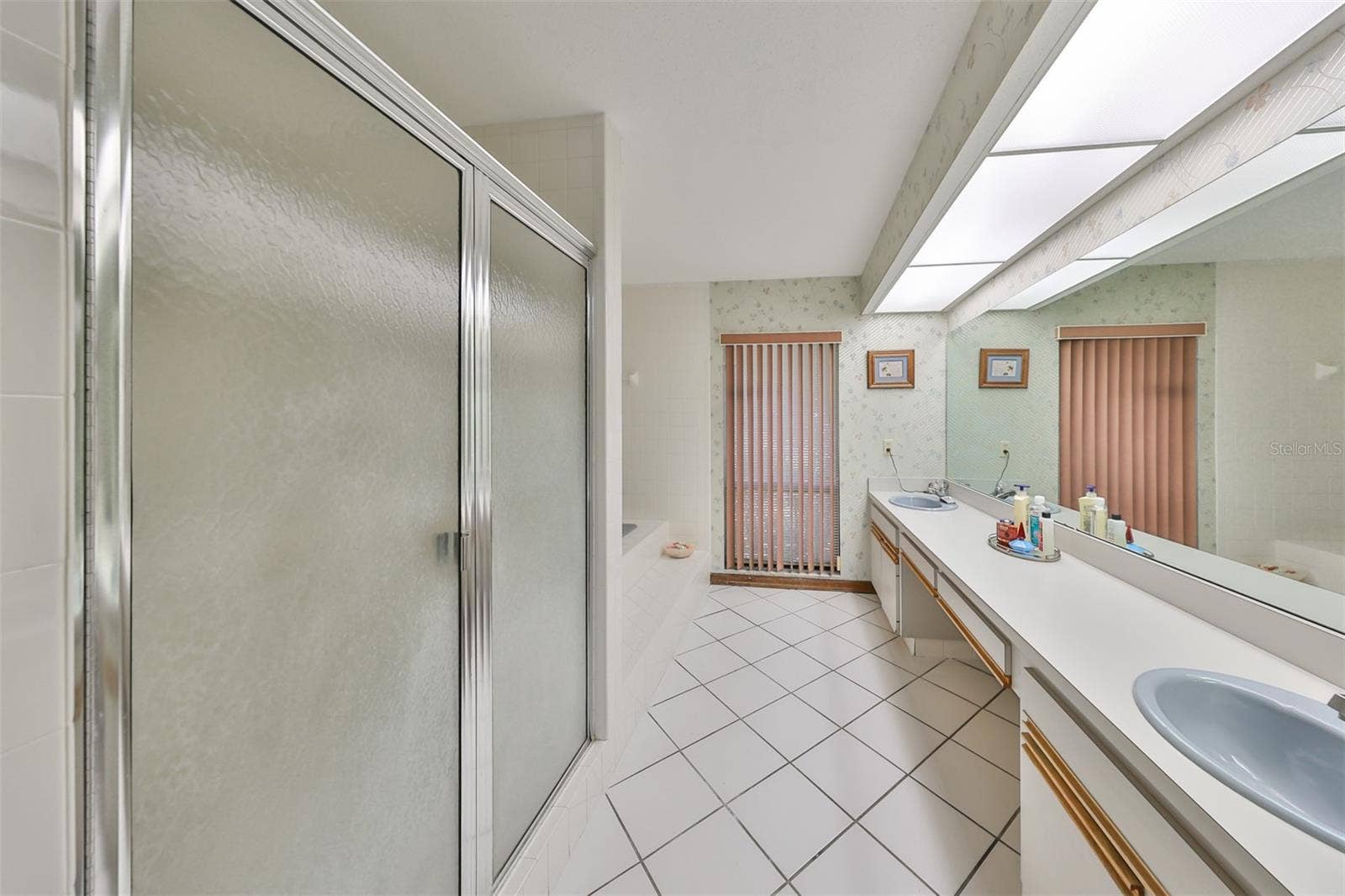 2609 MANOR OAK DRIVE, Valrico, FL 33596 Primary ensuite bathroom with dual sinks, soaking tube, private toilet room and a window for natural sunshine