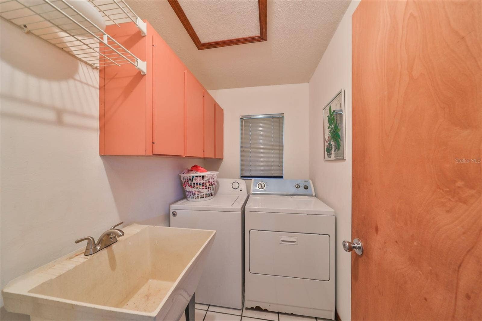 2609 MANOR OAK DRIVE, Valrico, FL 33596 Laundry room has utility sink and shelving