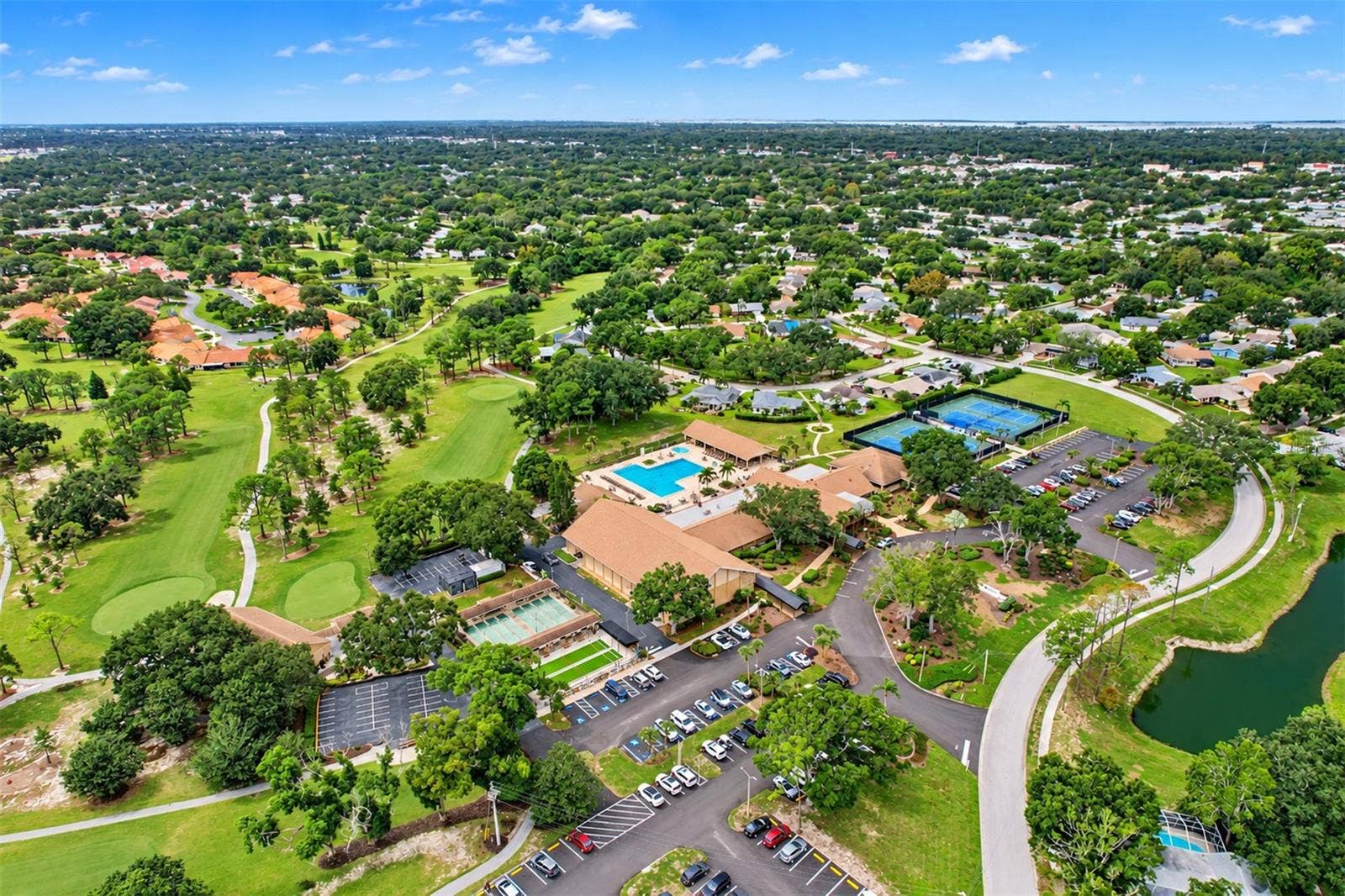 Aerial showing the massive Highland Lakes clubhouse and outside recreational facilities