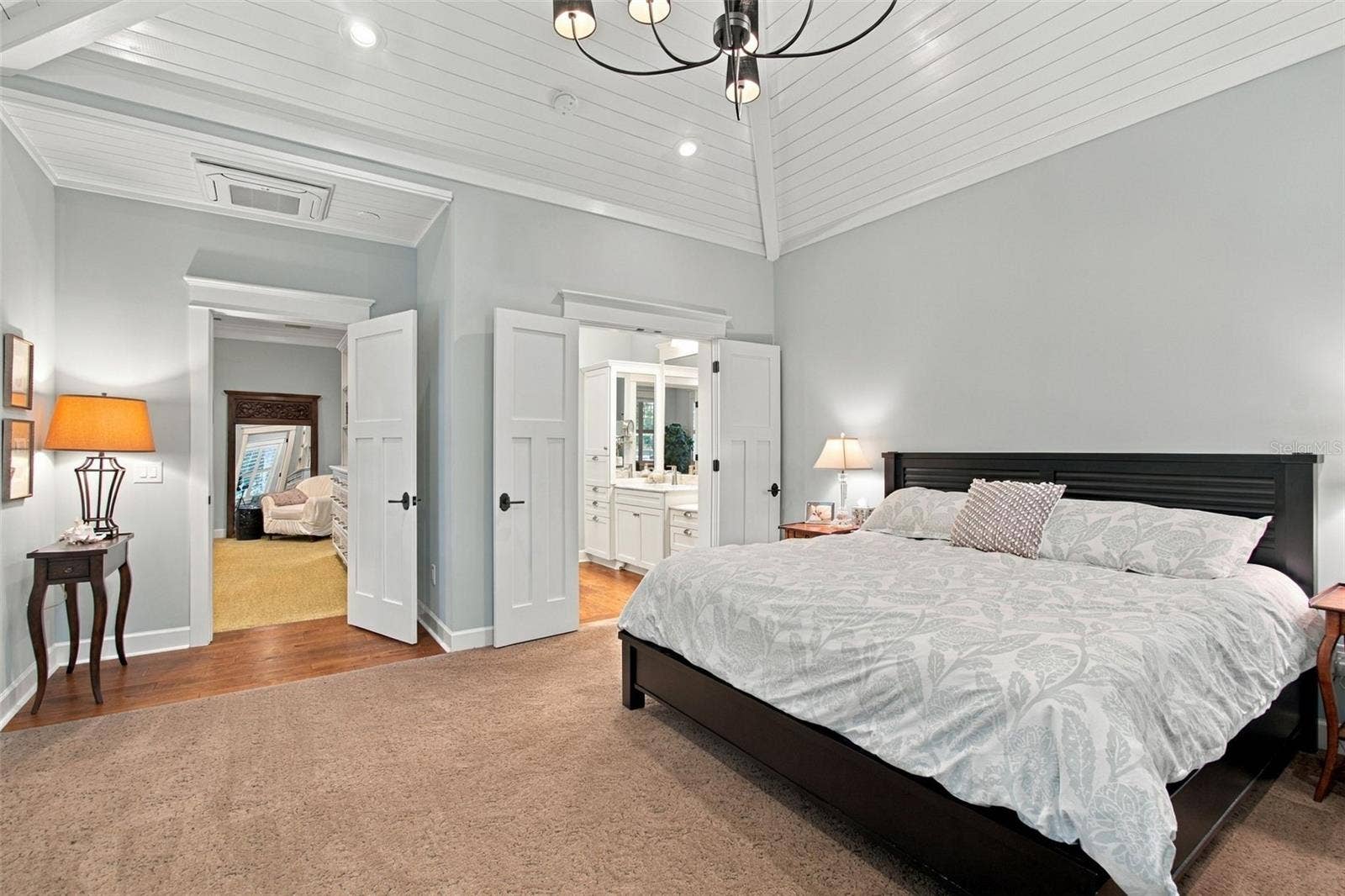 First flood Primary Bedroom with beautiful valuted ceiling with custom wood details..