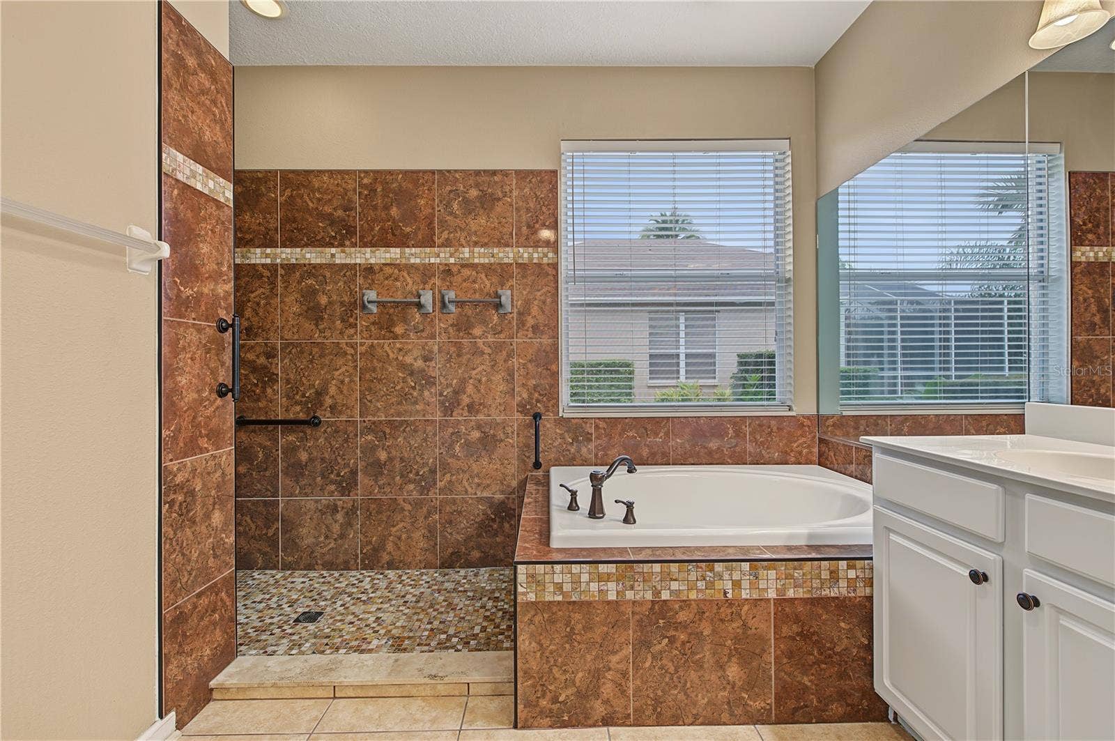 Master Bathroom, separate tub and shower, double vanities and a ceiling fan.