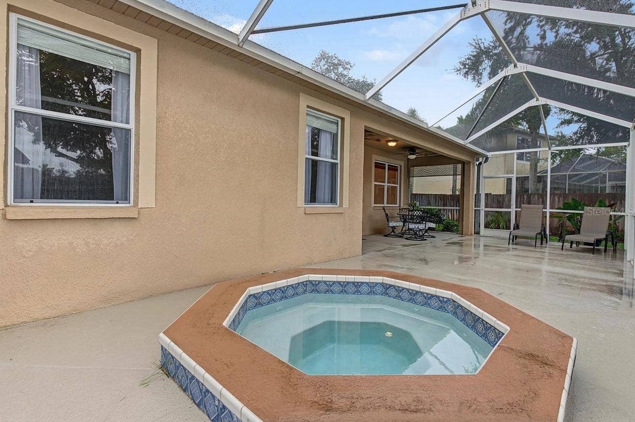 Lanai with spa overlooking the pond