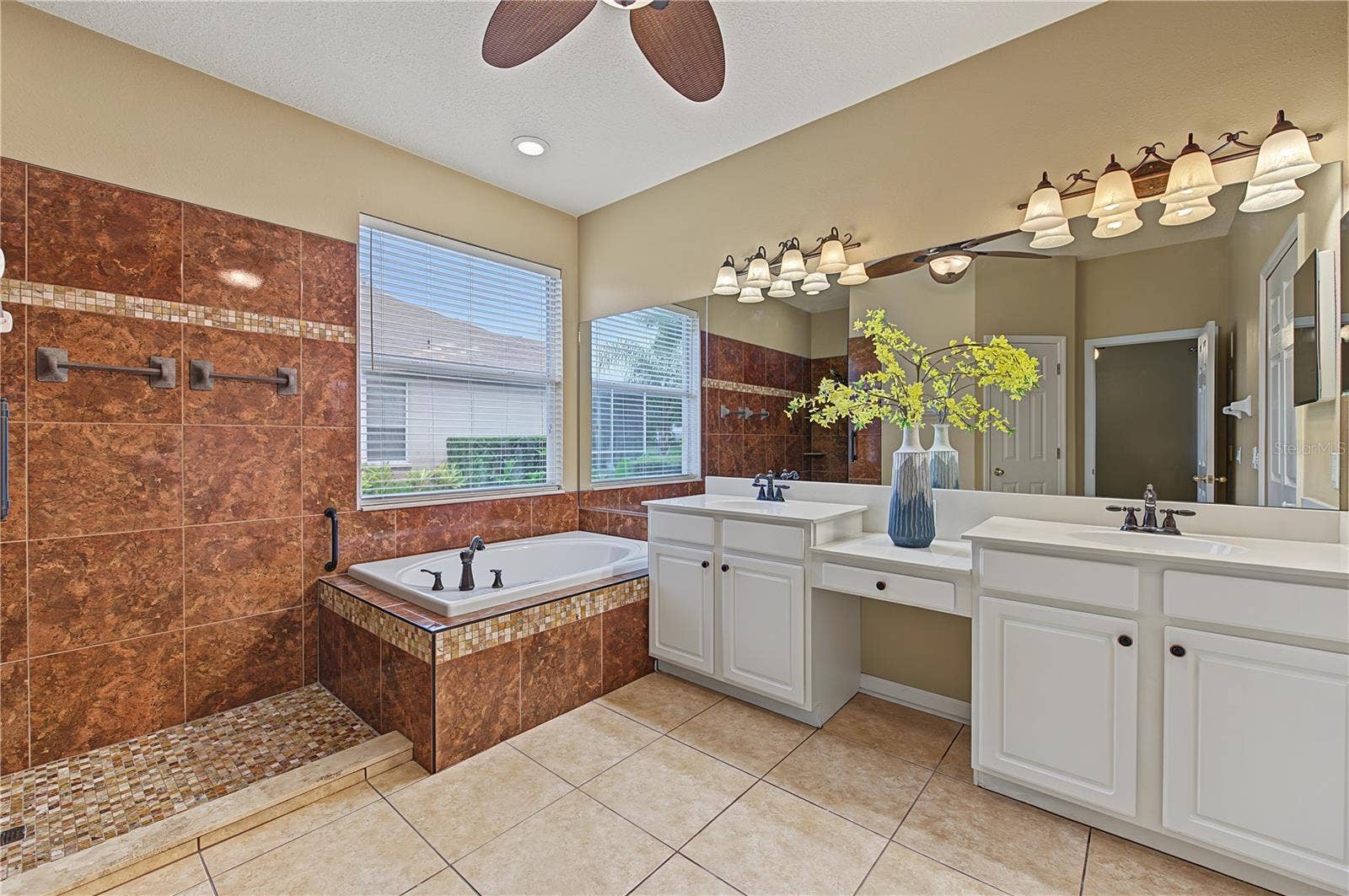Master Bathroom, separate tub and shower, double vanities and a ceiling fan.