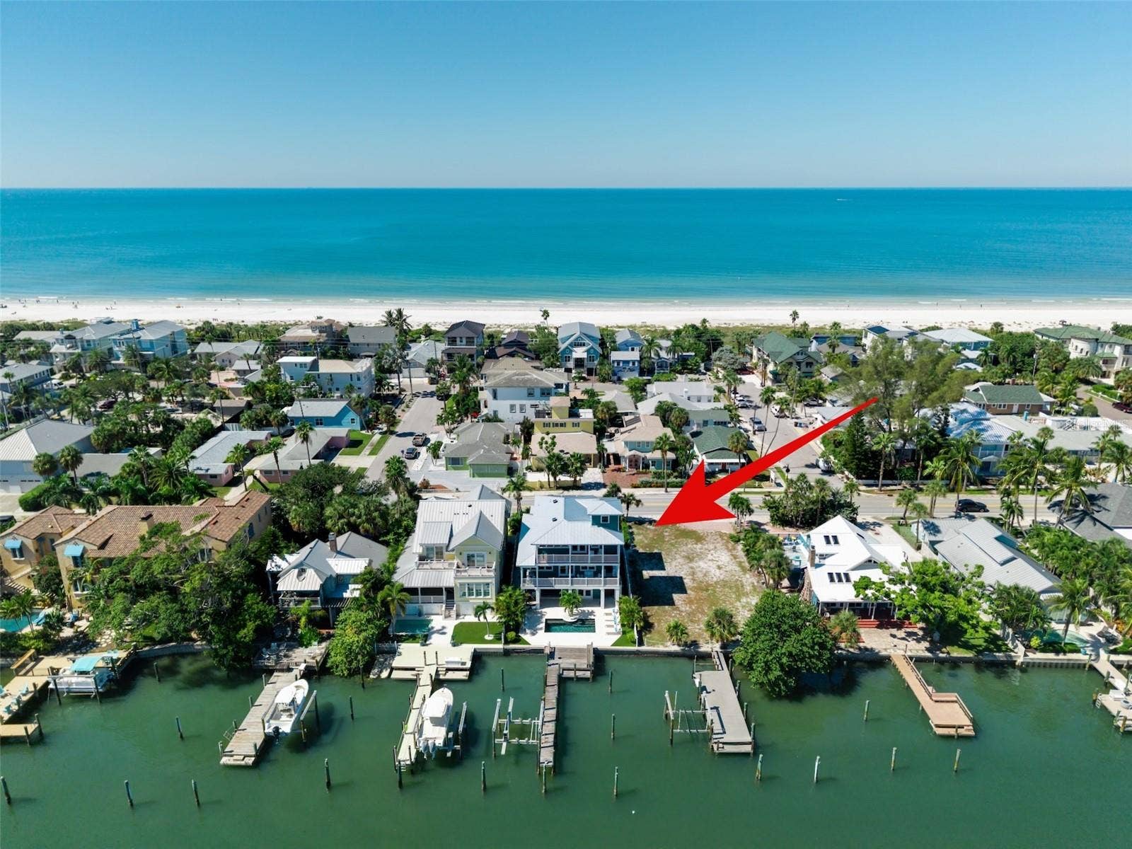 Count them 1, 2, 3 homes between the home and the white sandy beach