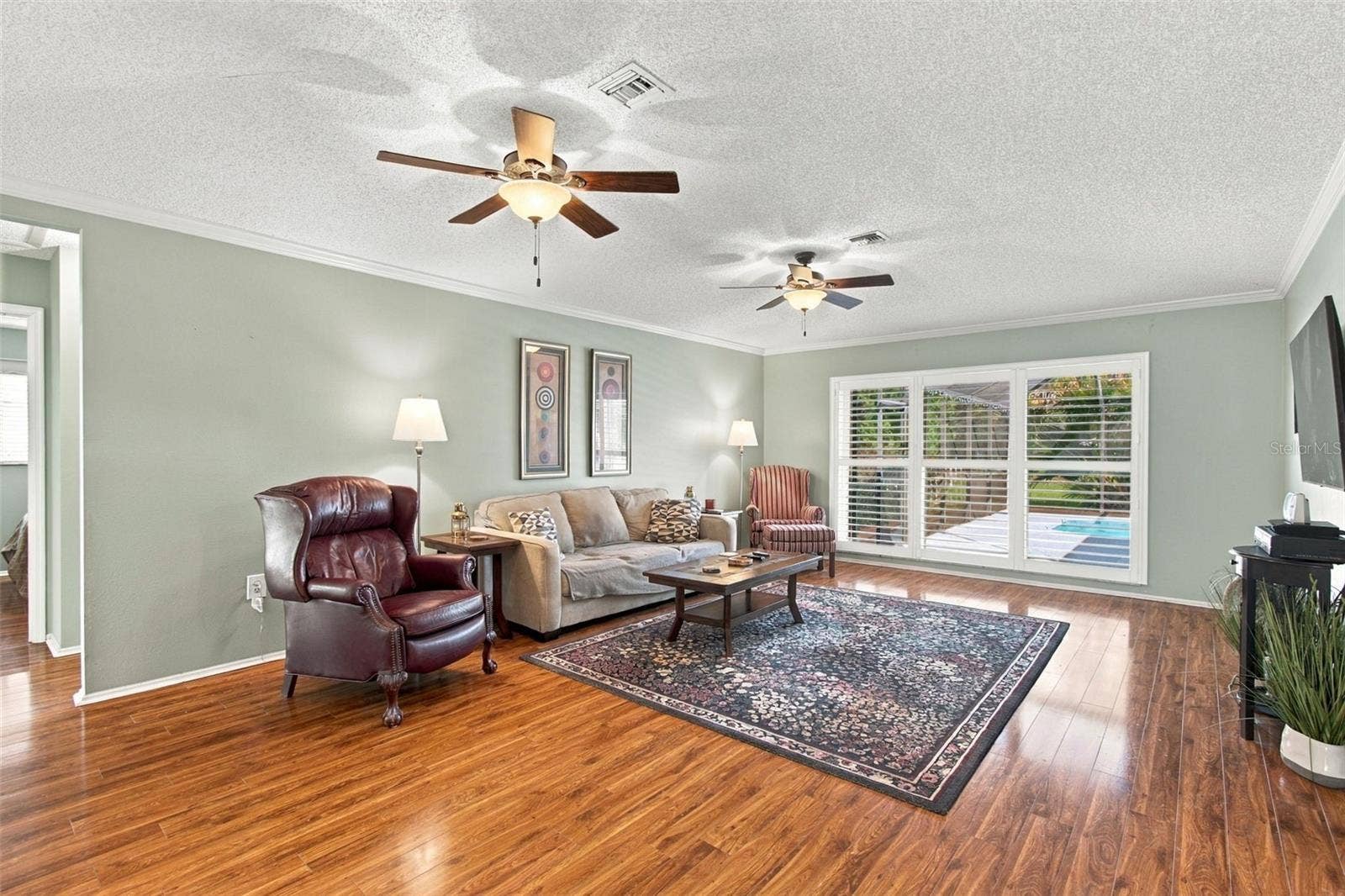 5404 80TH AVENUE CIRCLE E, Palmetto, FL 34221 Living Room with Plantation Shutters