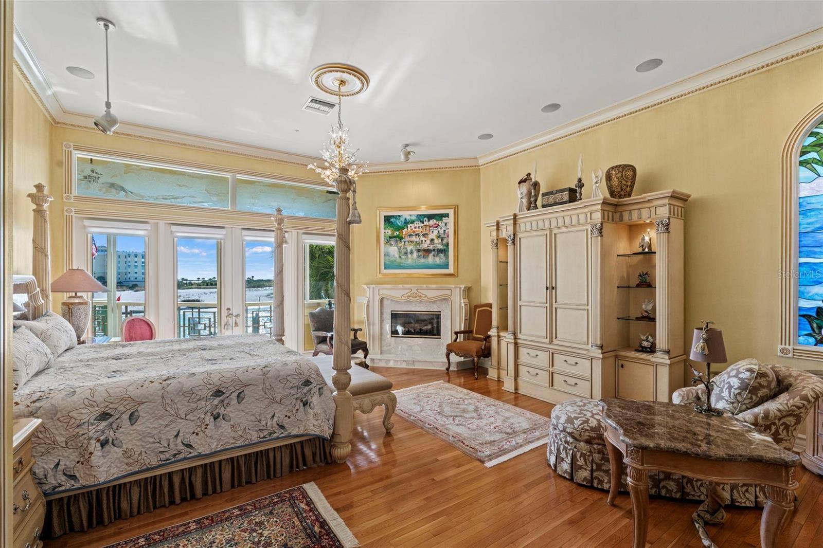 964 MONTE CRISTO BOULEVARD, Tierra Verde, FL 33715 Primary Suite with Harwood Floors, Fireplace, Crown Molding and French Doors to the Balcony
