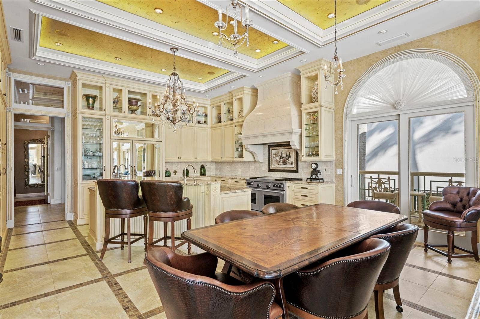 964 MONTE CRISTO BOULEVARD, Tierra Verde, FL 33715 Dining Area in the Great Room with Doors to the Grilling Porch