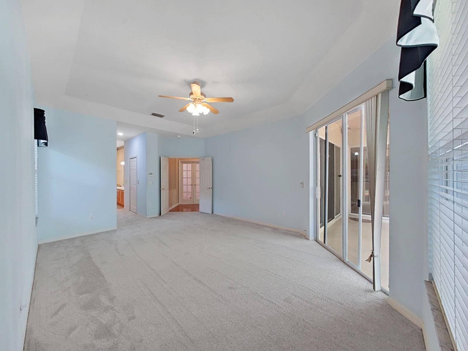 14915 DEVONSHIRE WOODS PLACE, Tampa, FL 33624 Primary Bedroom ~ Doors Open to Lanai