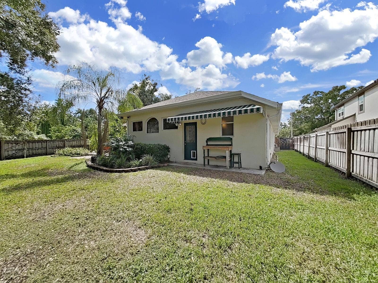 14915 DEVONSHIRE WOODS PLACE, Tampa, FL 33624 Back Garden ~ Canopy over Additional Back Entrance ~ Completely Fenced