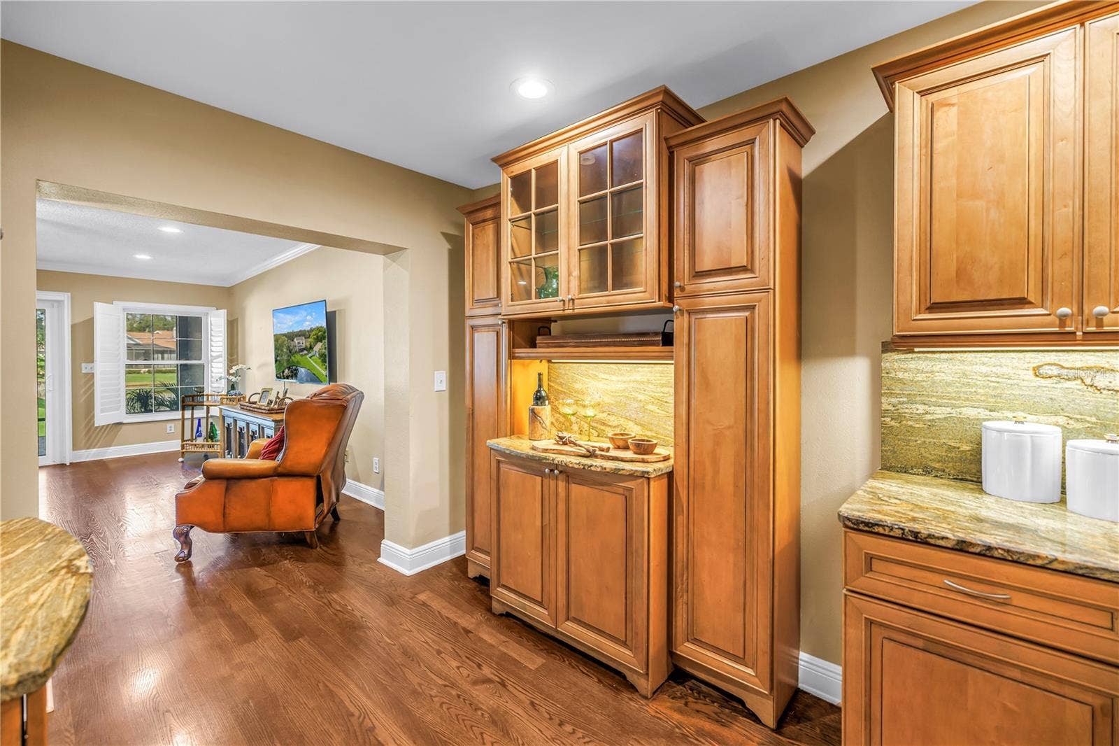 868 GLADES COURT NE, St Petersburg, FL 33702 This space features a matching bar area for charcuterie or appetizers, positioned opposite the dedicated beverage station. The design includes matching granite countertops and a coordinated backsplash. The room is fully equipped and staged for holiday entertaining.