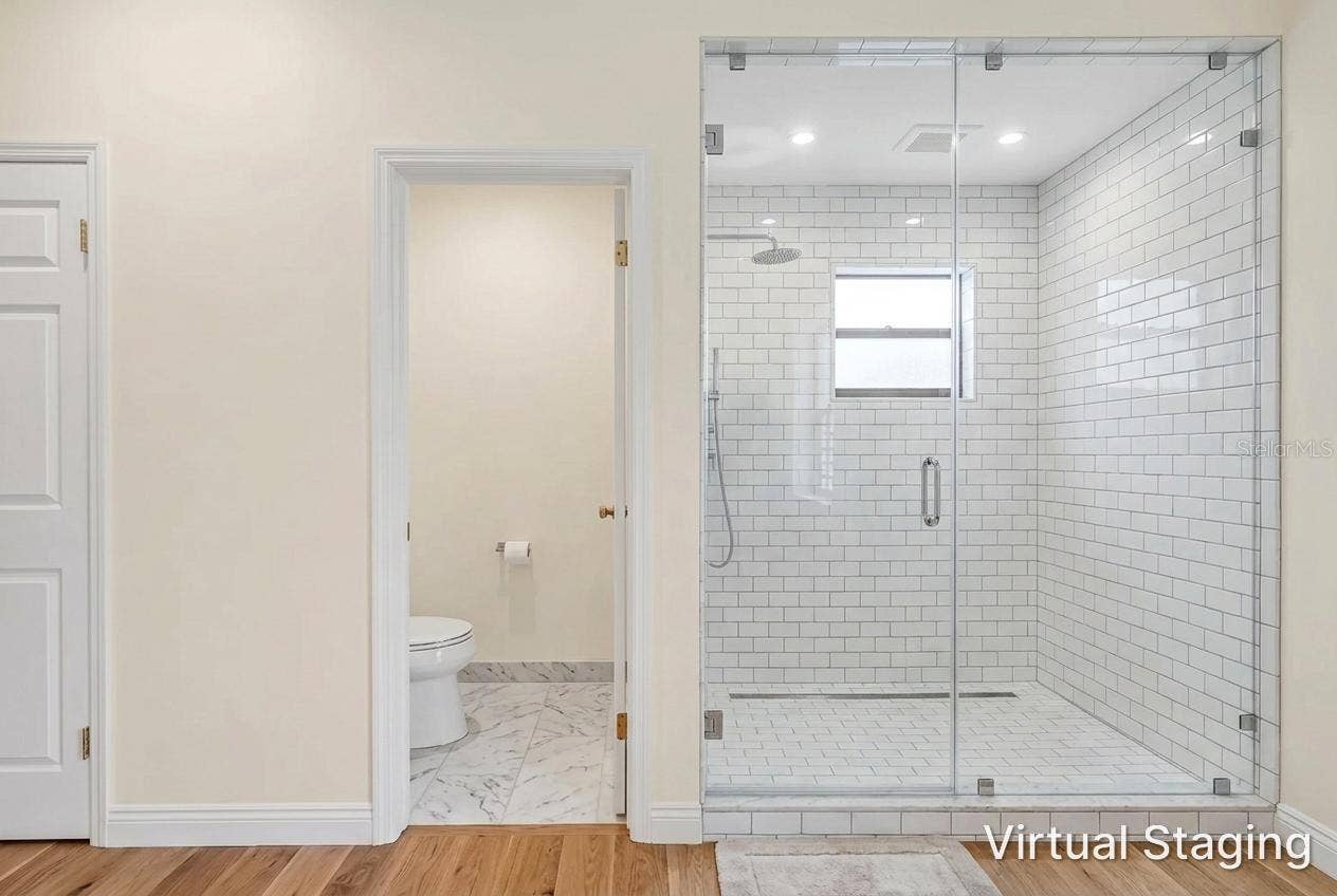 1186 GASPARILLA DRIVE NE, St Petersburg, FL 33702 Virtual rendering of new flooring and paint for toilet room and same adjacent shower wall with virtual update to glass walls and tile.
