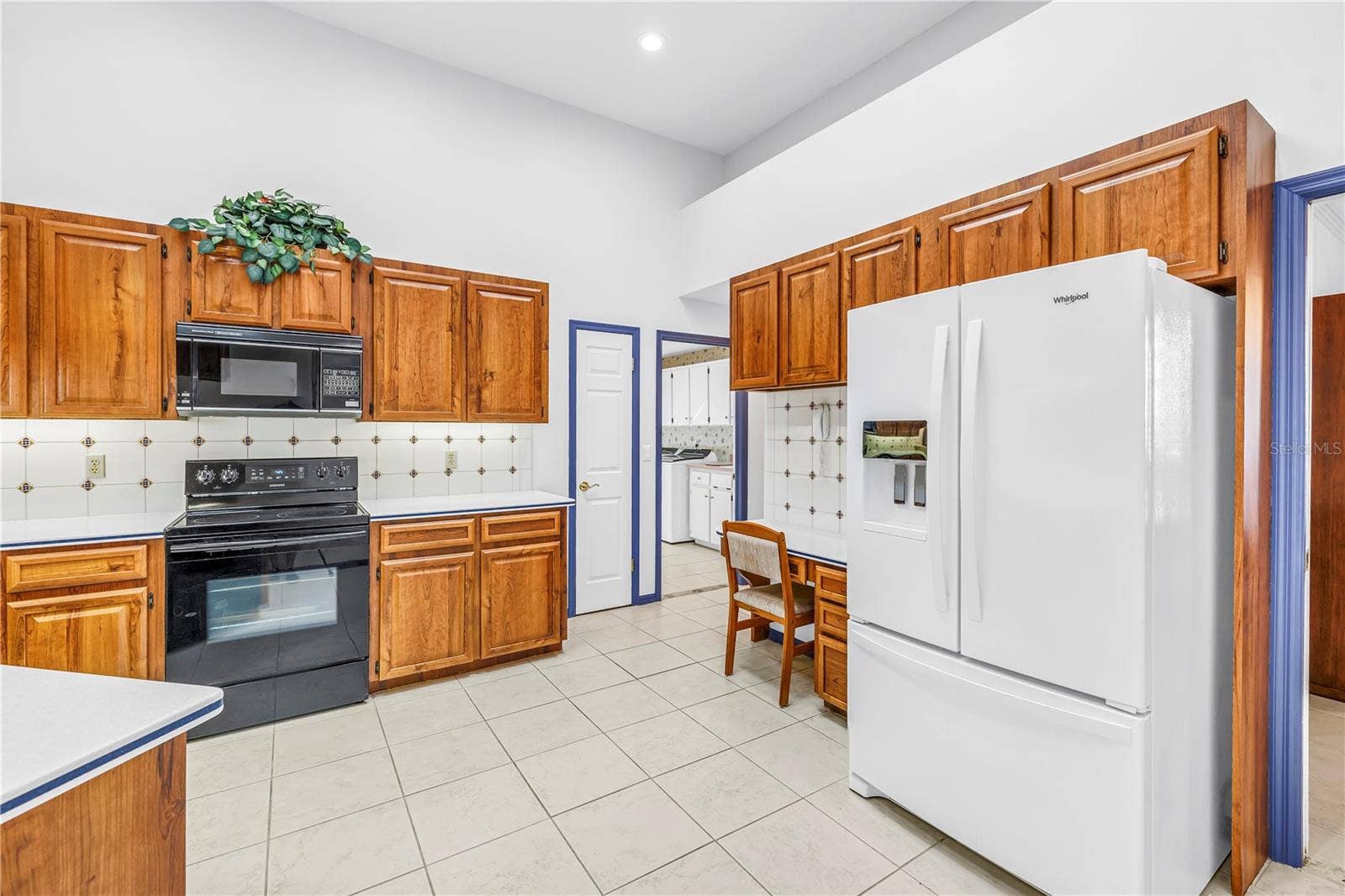 1186 GASPARILLA DRIVE NE, St Petersburg, FL 33702 Garage access, large walk-in pantry, laundry room, all on this side of the house. Newer refrigerator.