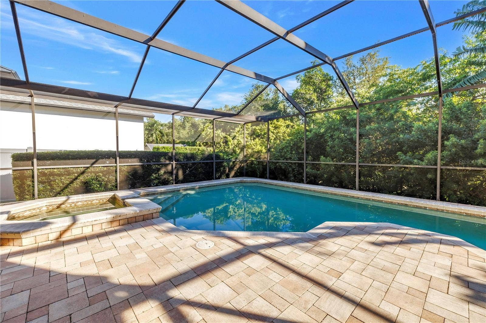 1186 GASPARILLA DRIVE NE, St Petersburg, FL 33702 This beautifully designed paver pool deck is engineered to stay cool during the summer and warm in the winter, providing year-round comfort for outdoor relaxation.