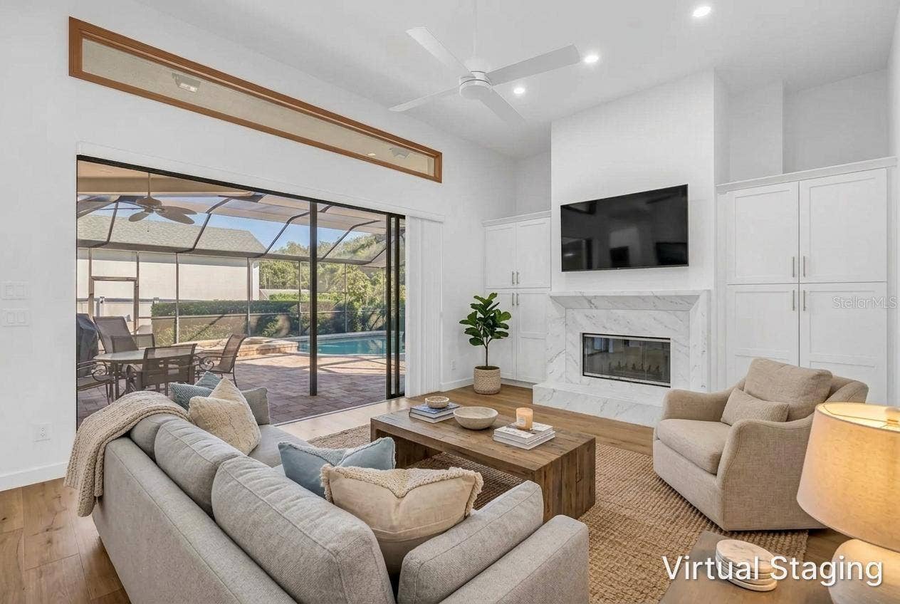 1186 GASPARILLA DRIVE NE, St Petersburg, FL 33702 Virtual Updates and staging from previous photo. New Flooring, Fireplace refacing and hardwood flooring, and staging furniture.