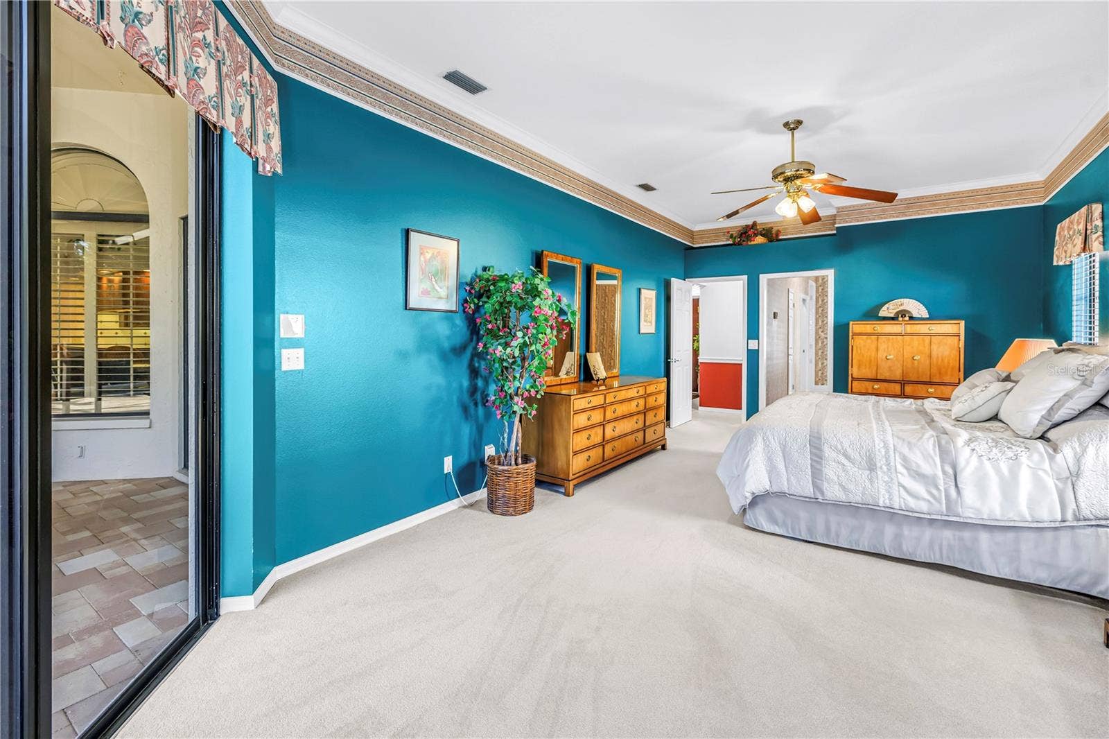 1186 GASPARILLA DRIVE NE, St Petersburg, FL 33702 Primary Bedroom with doors to en suite bath and living room. 10 Foot Ceilings, windows and (2) 8-Foot sliders to the pool deck. SEE VIRTUAL RENDERING IN PHOTO 61
