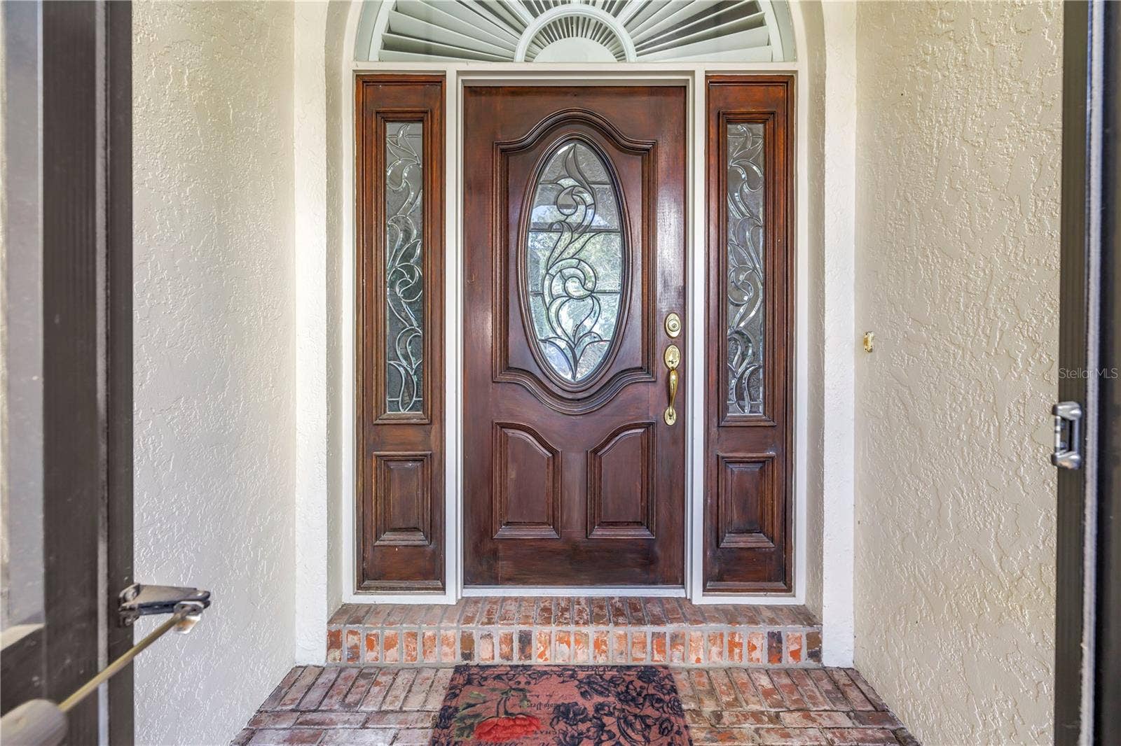 1186 GASPARILLA DRIVE NE, St Petersburg, FL 33702 Beautiful front door featuring solid wood construction and elegant leaded glass. This upscale entry is also screened, allowing for refreshing natural breezes.