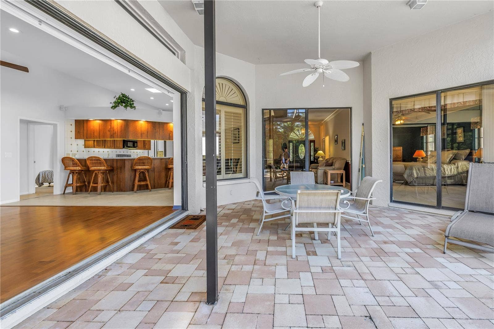 1186 GASPARILLA DRIVE NE, St Petersburg, FL 33702 This property features 8-foot, 3-panel sliding glass doors that pocket completely to provide seamless transition from the great room to the outdoor pool lanai, perfect for indoor-outdoor living.