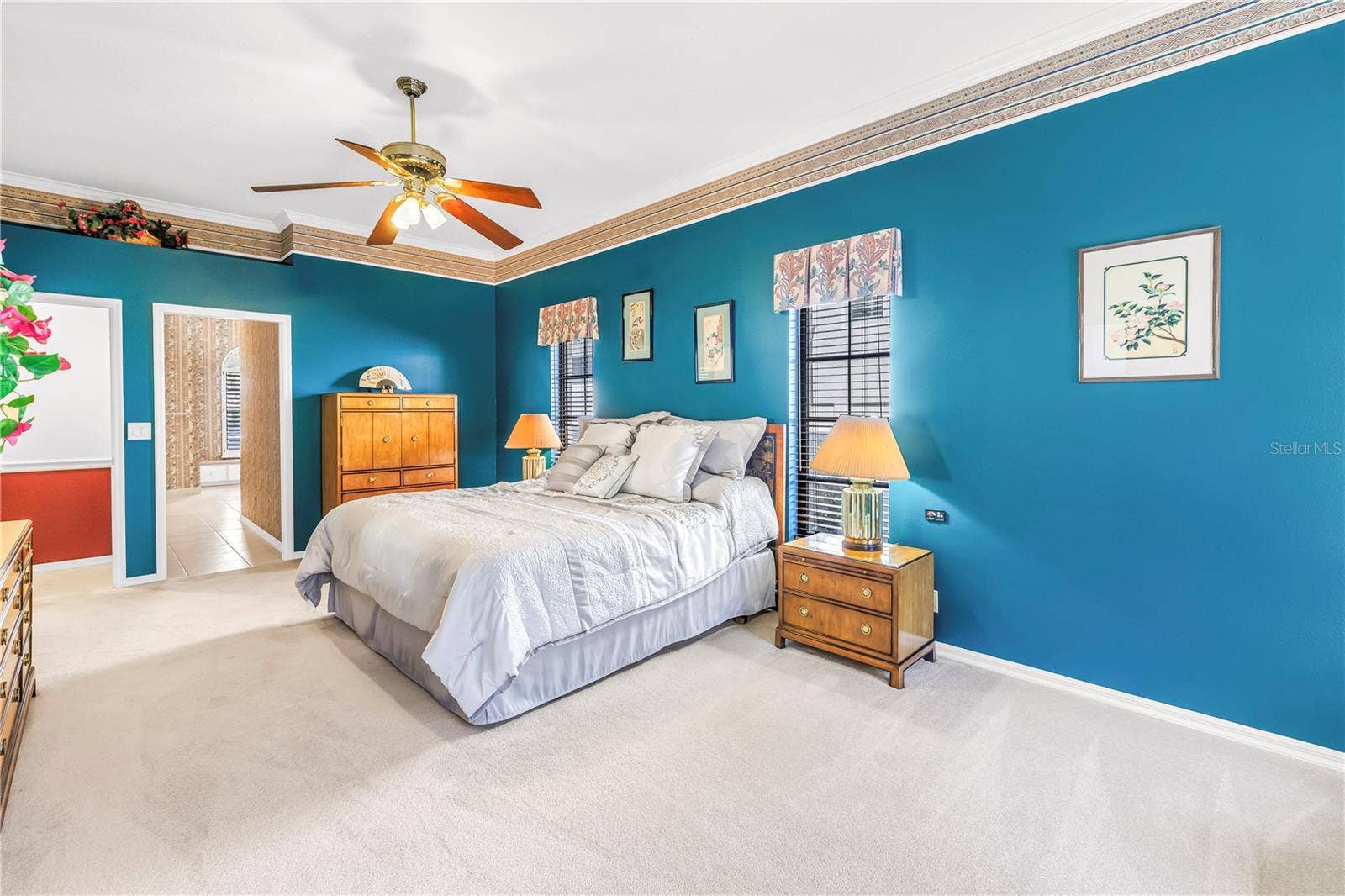 1186 GASPARILLA DRIVE NE, St Petersburg, FL 33702 Primary Bedroom with doors to en suite bath and living room. 10 Foot Ceilings, windows and (2) 8-Foot sliders to the pool deck. SEE VIRTUAL RENDERING IN PHOTO 61