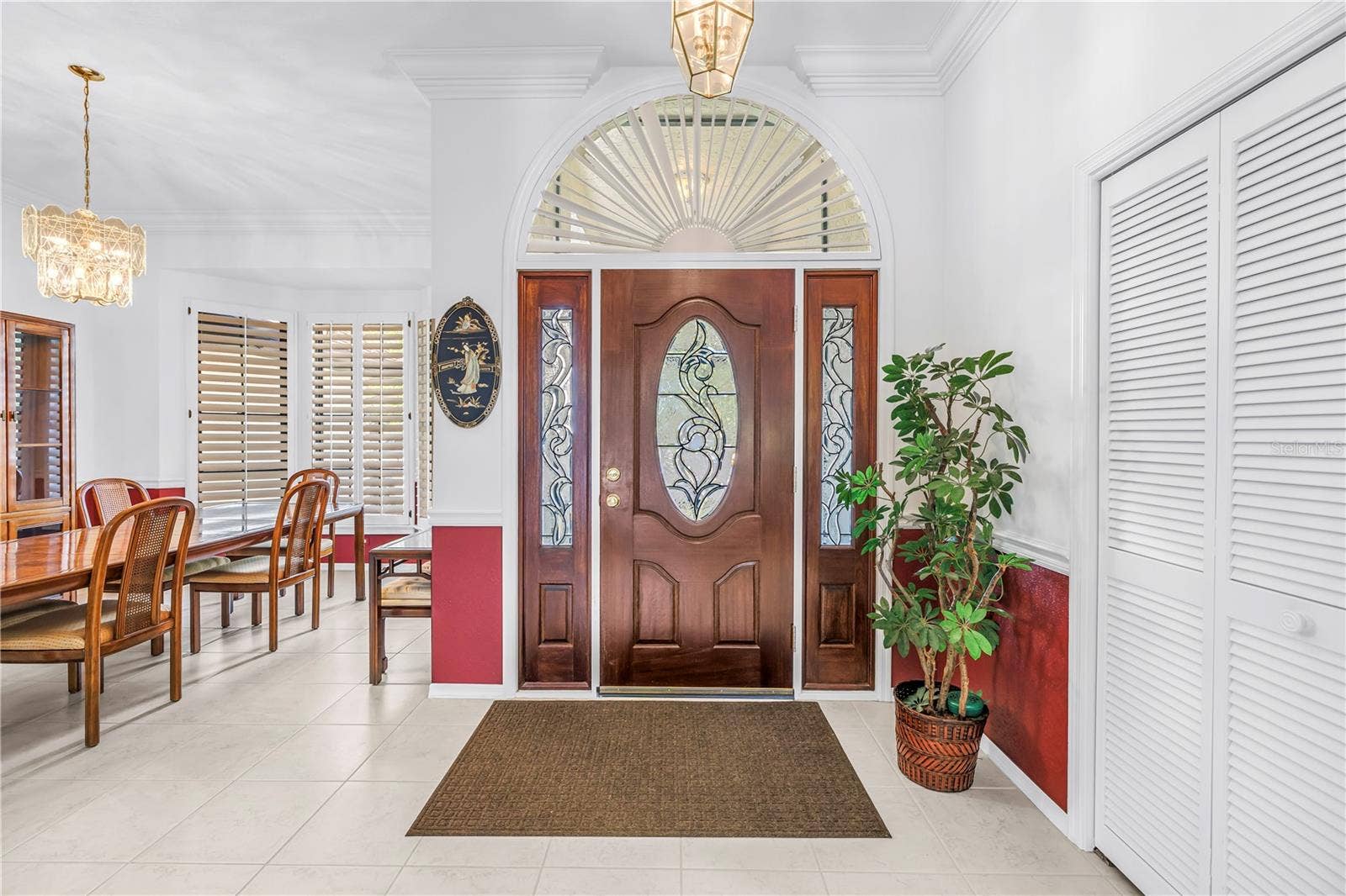1186 GASPARILLA DRIVE NE, St Petersburg, FL 33702 Foyer and adjacent formal dining room featuring abundant natural light and oversized windows.