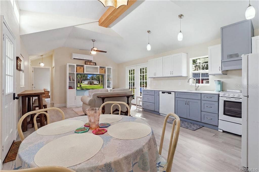 6230 W GLEN ROBBIN COURT, Crystal River, FL 34429 Open Living & Kitchen Area Light-filled OPEN FLOOR PLAN featuring VAULTED CEILINGS, attractive flooring, pendant lighting & a beautifully coordinated kitchen.