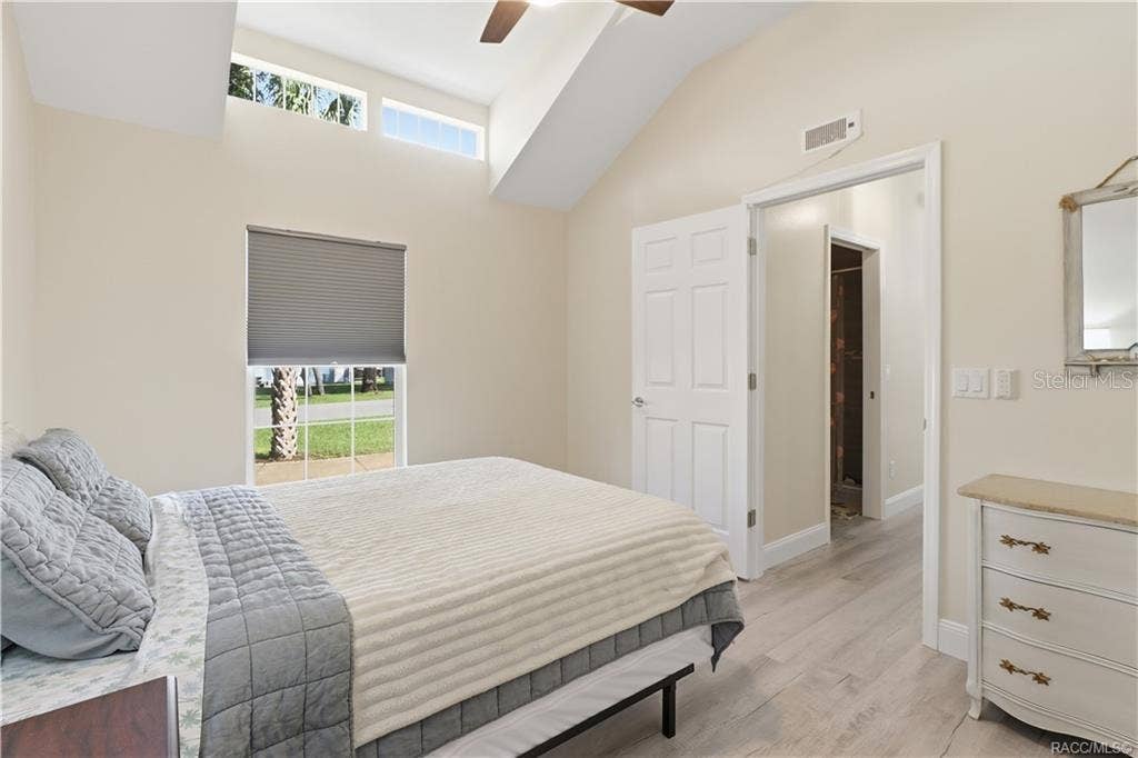 6230 W GLEN ROBBIN COURT, Crystal River, FL 34429 Bedroom Comfortable bedroom featuring VAULTED CEILINGS, luxury vinyl plank flooring, ceiling fan, spacious double closets & attractive furnishings.