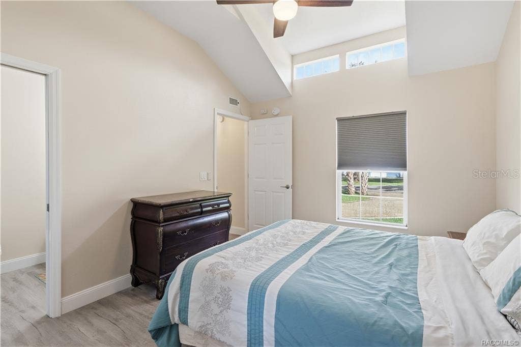 6230 W GLEN ROBBIN COURT, Crystal River, FL 34429 Primary Bedroom Another view of the cheerful bedroom showcasing its VAULTED CEILINGS, upper transom windows, natural light & comfortable layout.