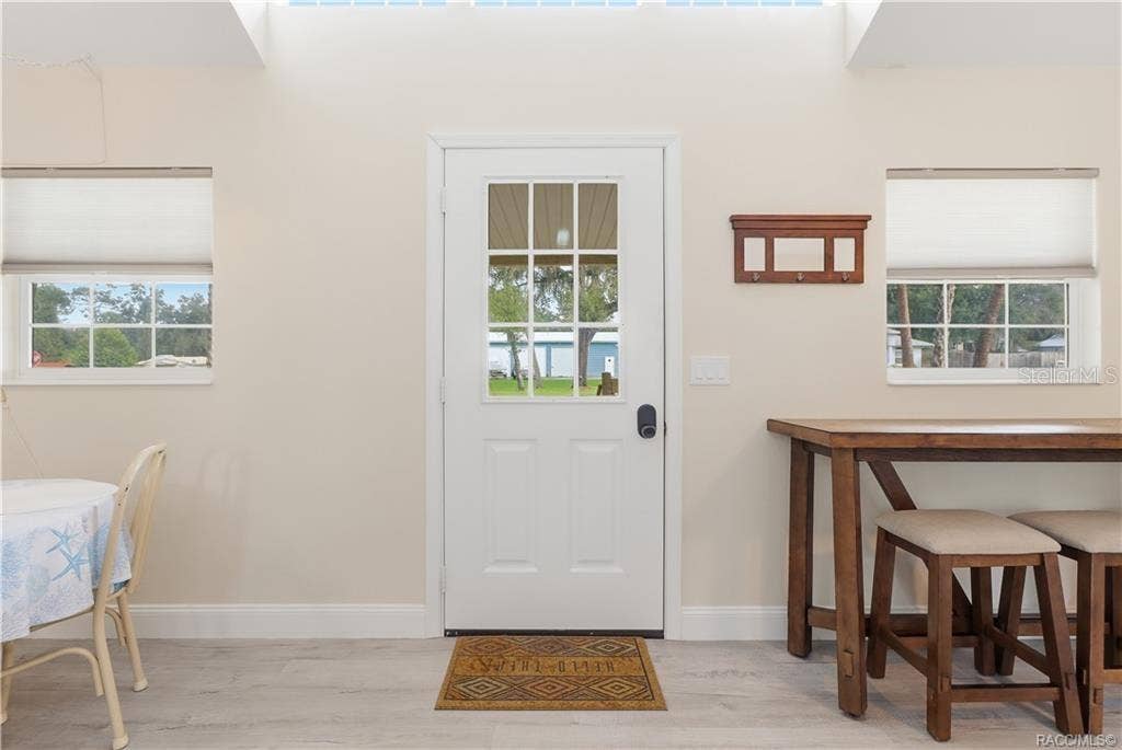 6230 W GLEN ROBBIN COURT, Crystal River, FL 34429 Front Entry Bright & welcoming entrance featuring a glass-paneled front door, natural light, attractive flooring & space for additional seating.