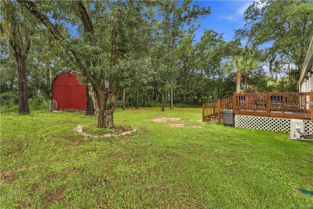 6230 W GLEN ROBBIN COURT, Crystal River, FL 34429 Spacious Backyard Enjoy the natural setting w/mature shade trees, green lawn, wooden rear deck & detached storage building. Plenty of outdoor space to enjoy!