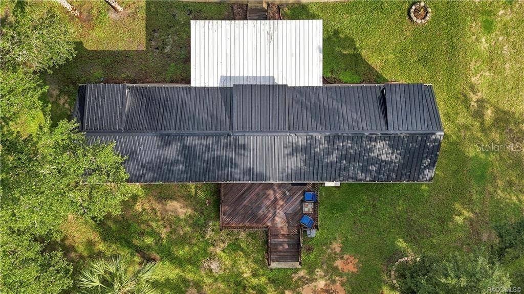 6230 W GLEN ROBBIN COURT, Crystal River, FL 34429 Aerial Roof & Deck View Bird's-eye perspective showcasing the METAL ROOF, covered front porch, spacious WOODEN REAR DECK & surrounding green space.