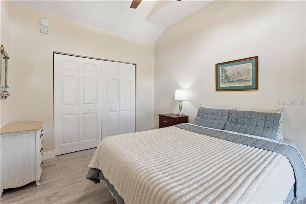 6230 W GLEN ROBBIN COURT, Crystal River, FL 34429 Bedroom Comfortable bedroom featuring VAULTED CEILINGS, luxury vinyl plank flooring, ceiling fan, spacious double closets & attractive furnishings.