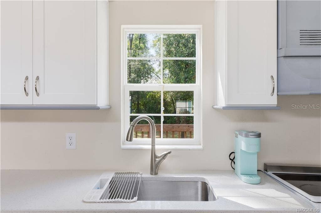 6230 W GLEN ROBBIN COURT, Crystal River, FL 34429 Kitchen Sink & Window Stainless-steel sink w/pull-down faucet, solid surface countertop & window overlooking the greenery outside.