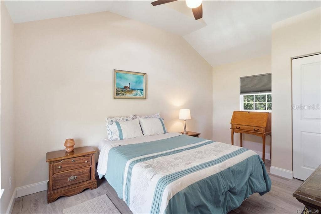 6230 W GLEN ROBBIN COURT, Crystal River, FL 34429 Primary Bedroom Cozy & inviting bedroom featuring VAULTED CEILINGS, luxury vinyl plank flooring, ceiling fan & coastal-inspired furnishings.
