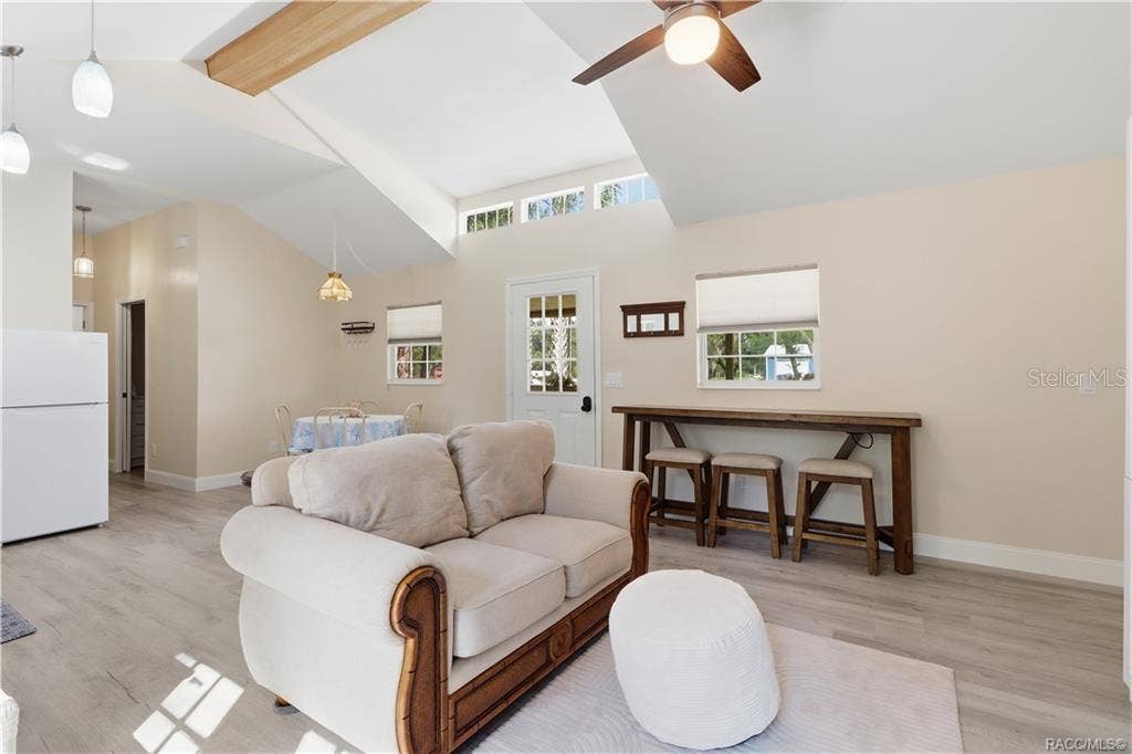 6230 W GLEN ROBBIN COURT, Crystal River, FL 34429 Open Floor Plan Natural light fills this cheerful living space featuring VAULTED CEILINGS, decorative wood beam, clerestory windows & a convenient breakfast bar area. An inviting place to relax or gather!