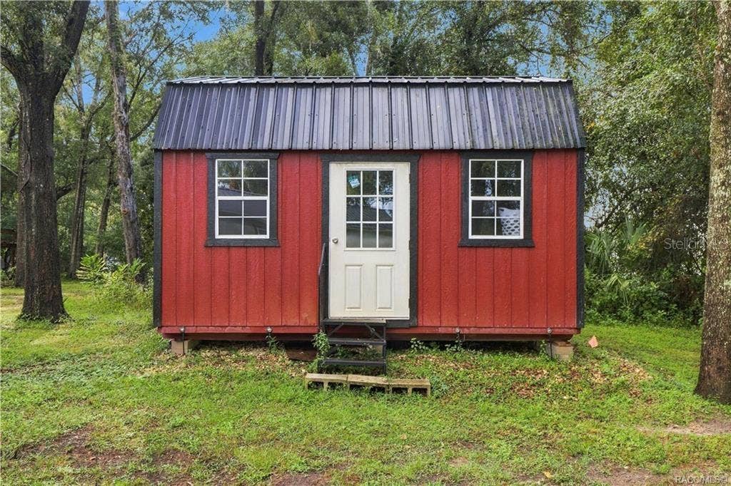 6230 W GLEN ROBBIN COURT, Crystal River, FL 34429 Detached Storage Building Charming RED DETACHED STORAGE BUILDING featuring a METAL ROOF, double windows & convenient entry door. A wonderful addition for storing lawn equipment, tools or outdoor essentials!