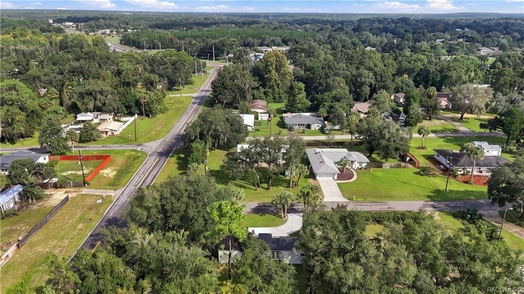6230 W GLEN ROBBIN COURT, Crystal River, FL 34429 Aerial Neighborhood View Elevated view highlighting the home's corner setting, surrounding residential neighborhood, mature trees & nearby roadways.