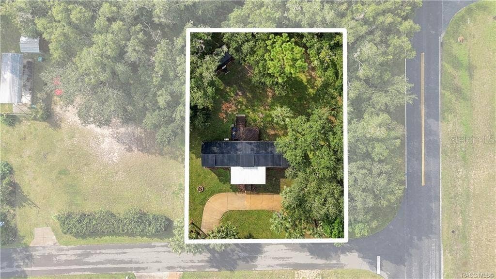 6230 W GLEN ROBBIN COURT, Crystal River, FL 34429 Aerial Property View Overhead perspective showcasing the home on its .29-ACRE CORNER LOT, surrounded by mature trees, greenery & a circular driveway.