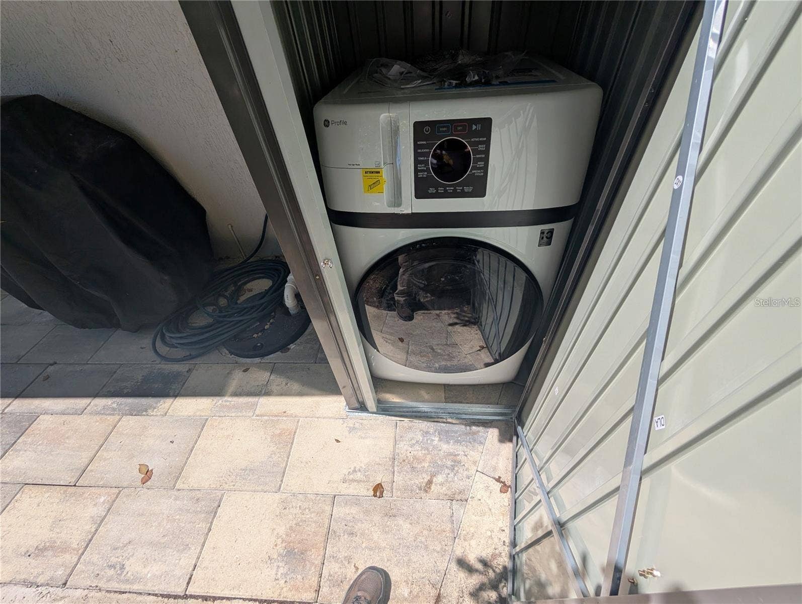 Stackable washer and dryer in outside shed