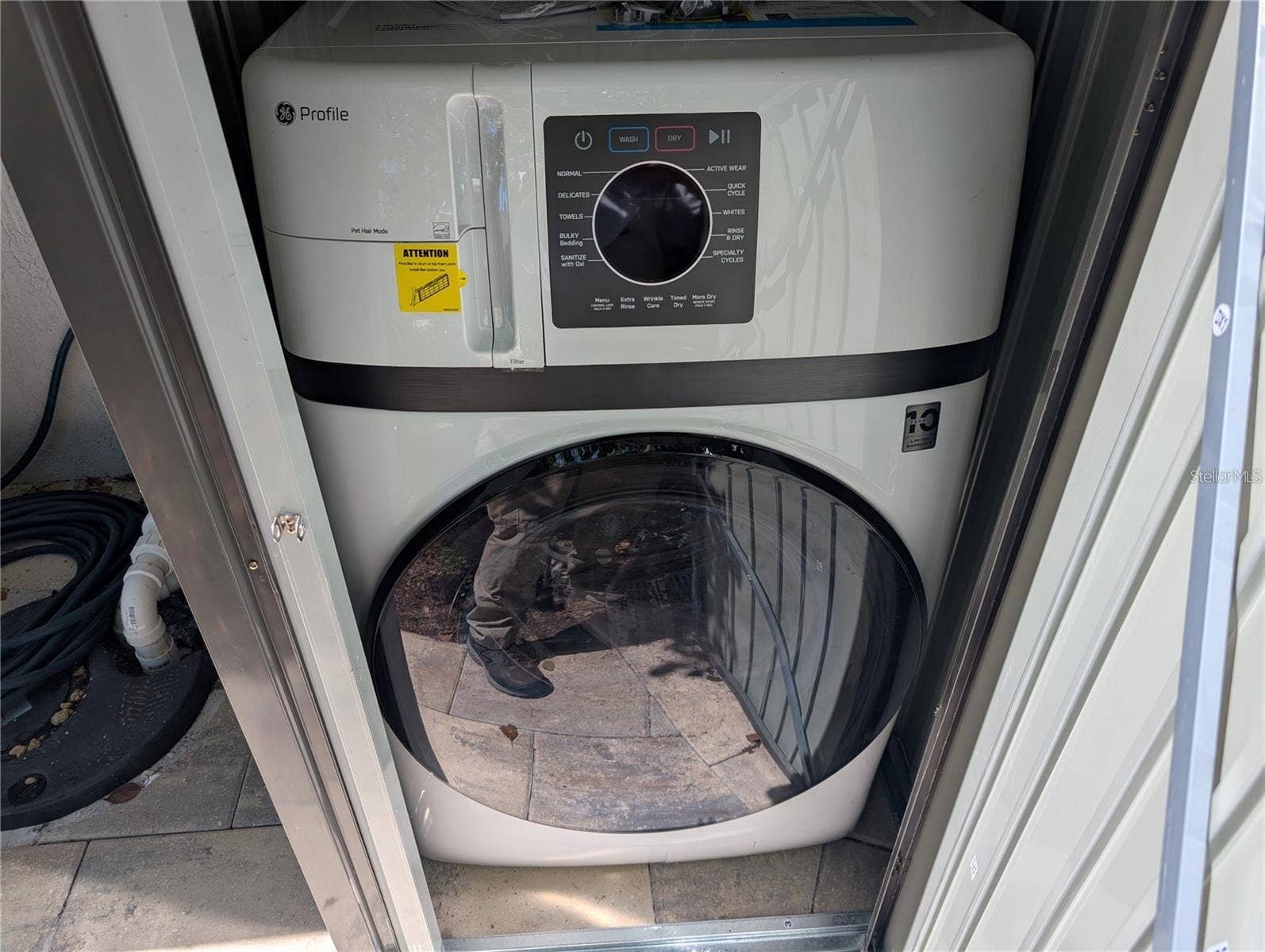 Stackable washer and dryer in outside shed