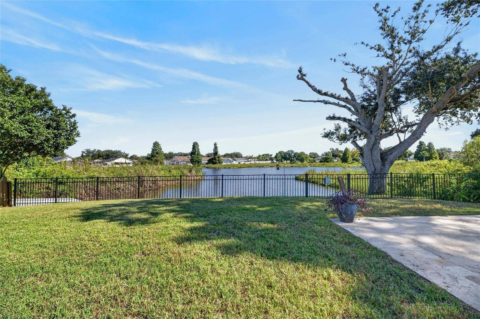 Lake front view with partial uncovered patio