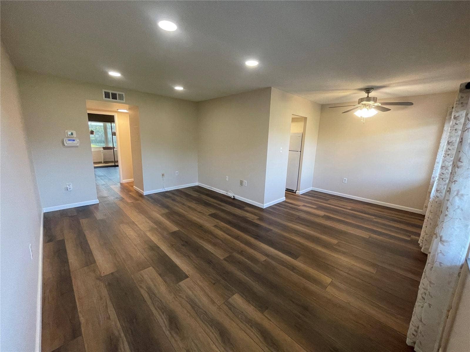View from Living Room to Rest of Living Room and Dining Area