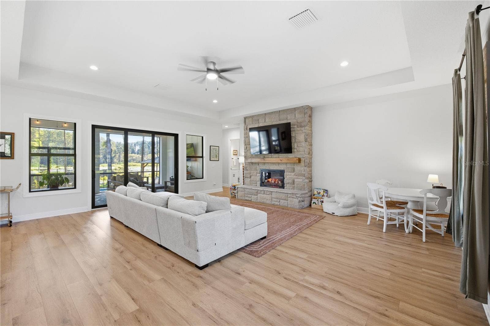2664 WILSKY ROAD, Land O Lakes, FL 34639 Stone detailed electric fireplace with hearth and 10 FT sliders.