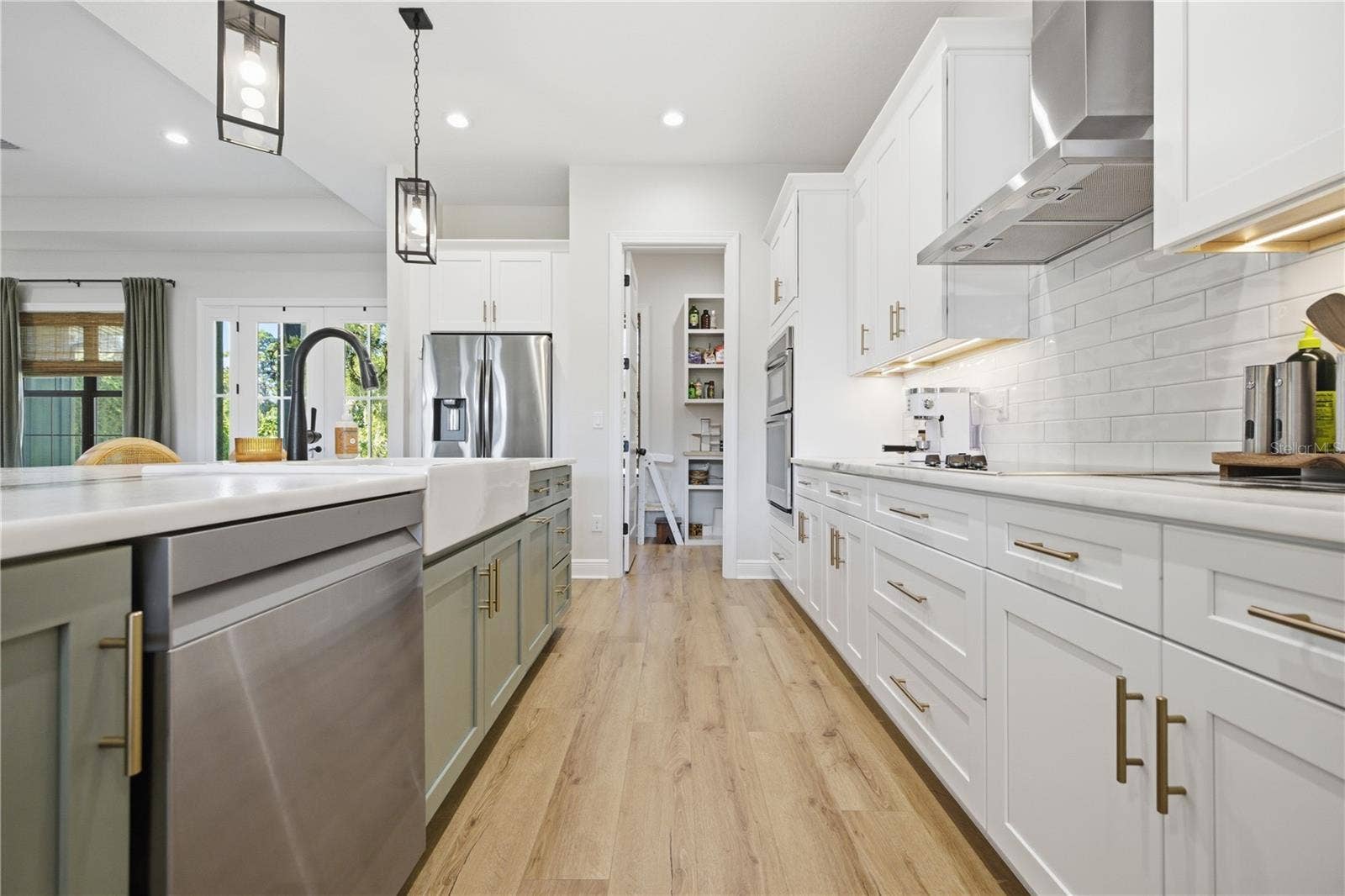 2664 WILSKY ROAD, Land O Lakes, FL 34639 custom cabinetry with 36 inch electric cooktop and sage green oversized island.