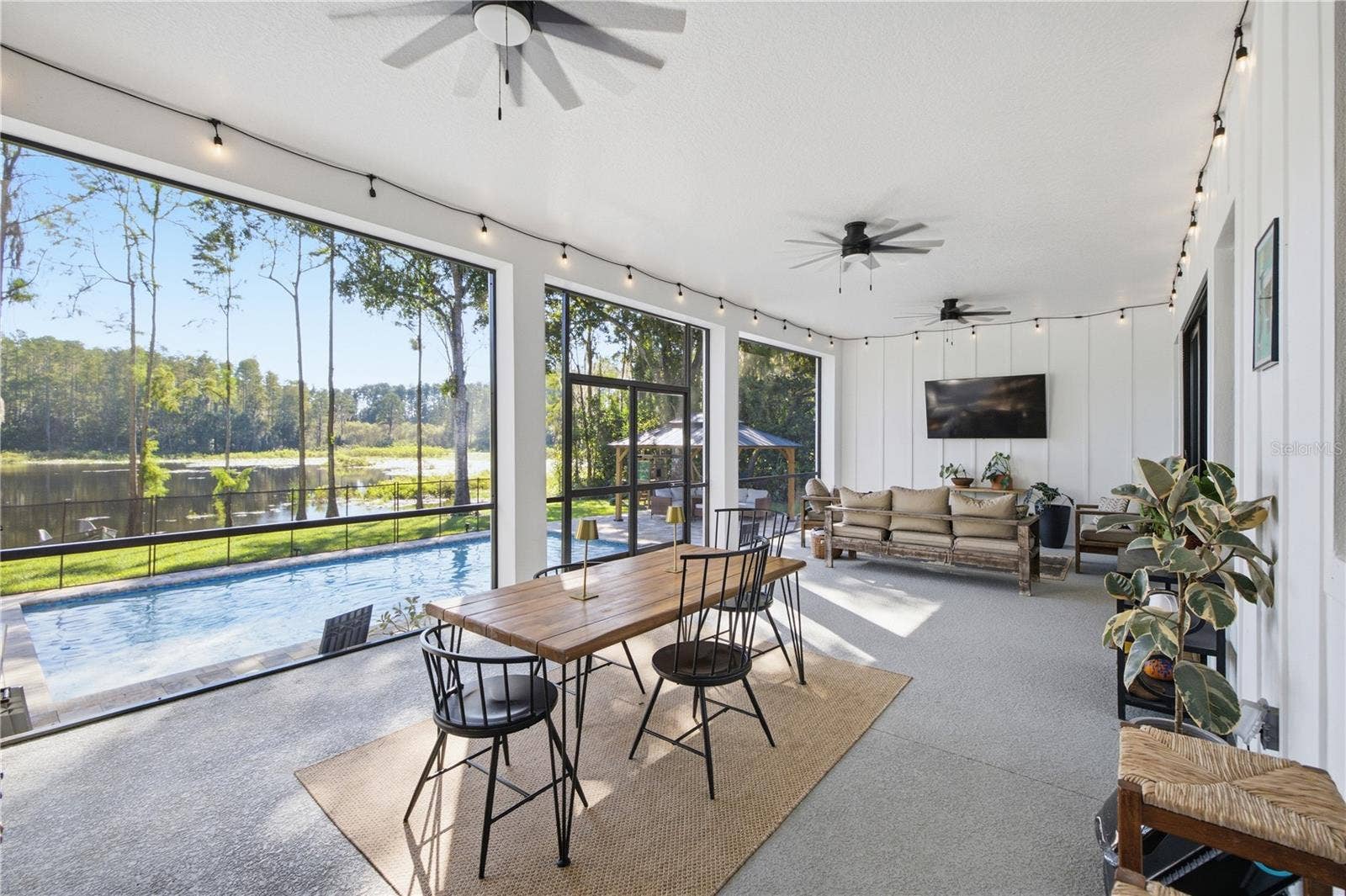 2664 WILSKY ROAD, Land O Lakes, FL 34639 32 FT+ covered, screened, rear porch with TV and fans.