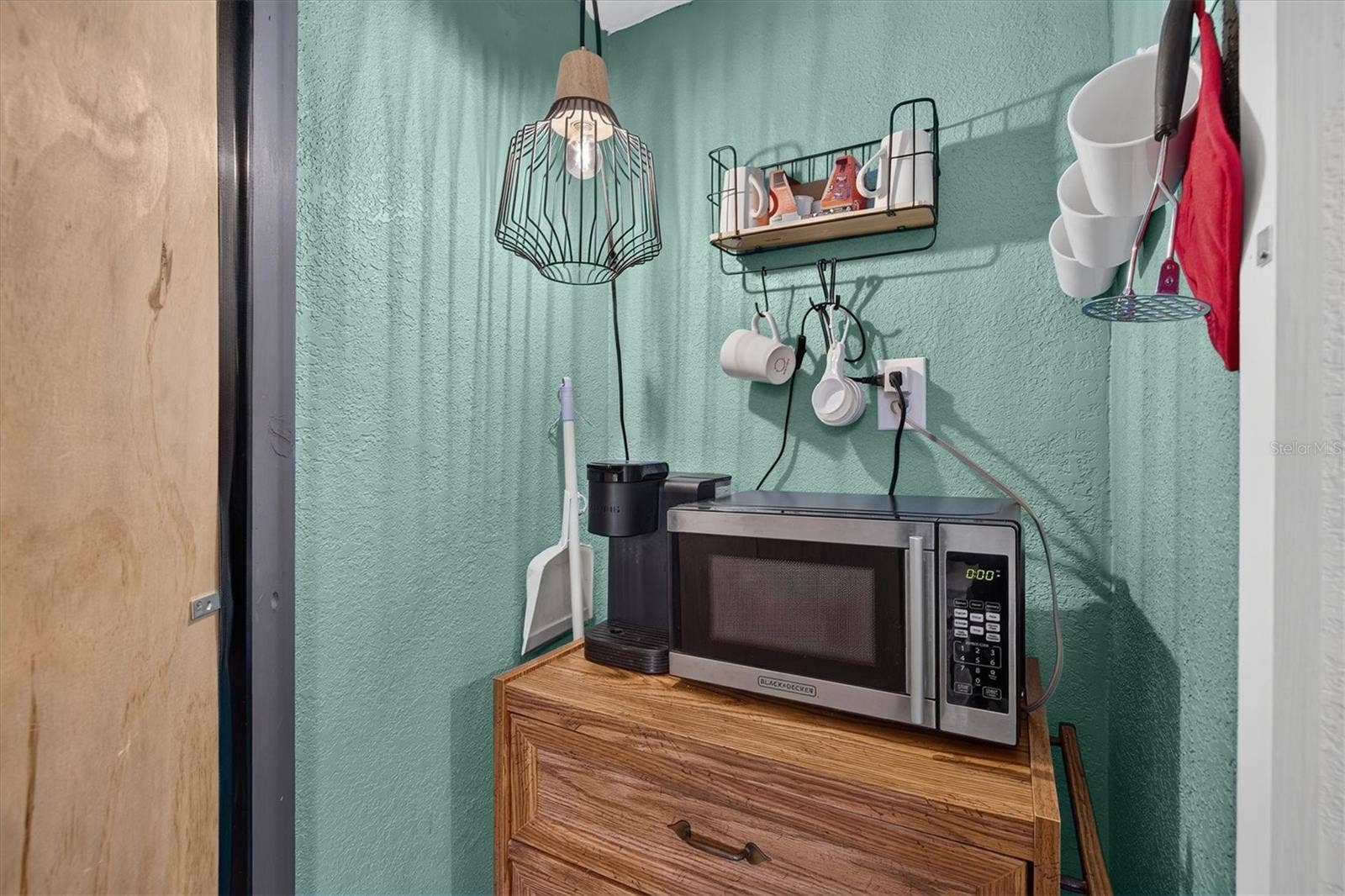 Pantry closet with microwave and storage.