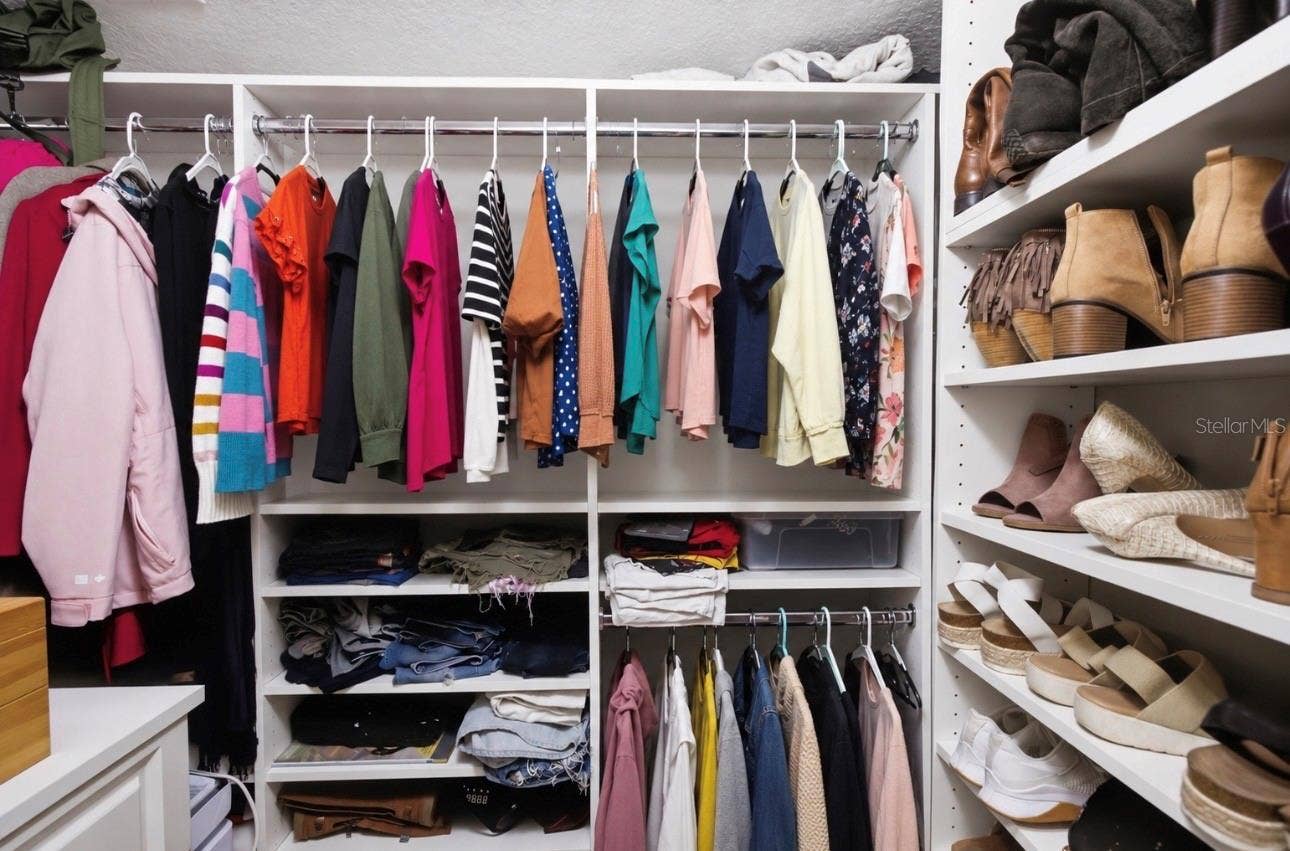 Primary Suite Walk in Closet with customized closet systems.