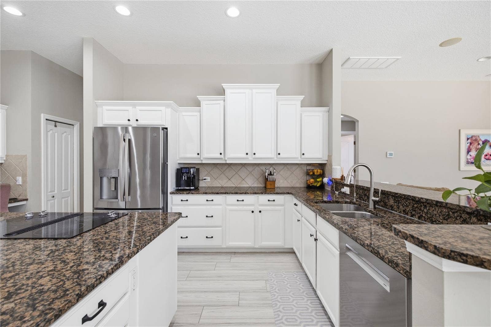 LARGE open kitchen with TONS of storage, wall mounted oven and microwave combo, island cooktop, tons of counterspace, etc.