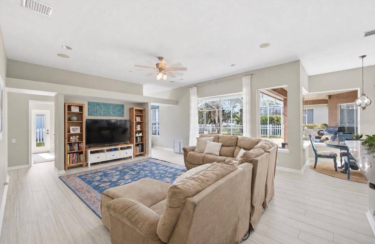 Secondary Den/Living Room behind the kitchen, with sliding doors to exterior.
