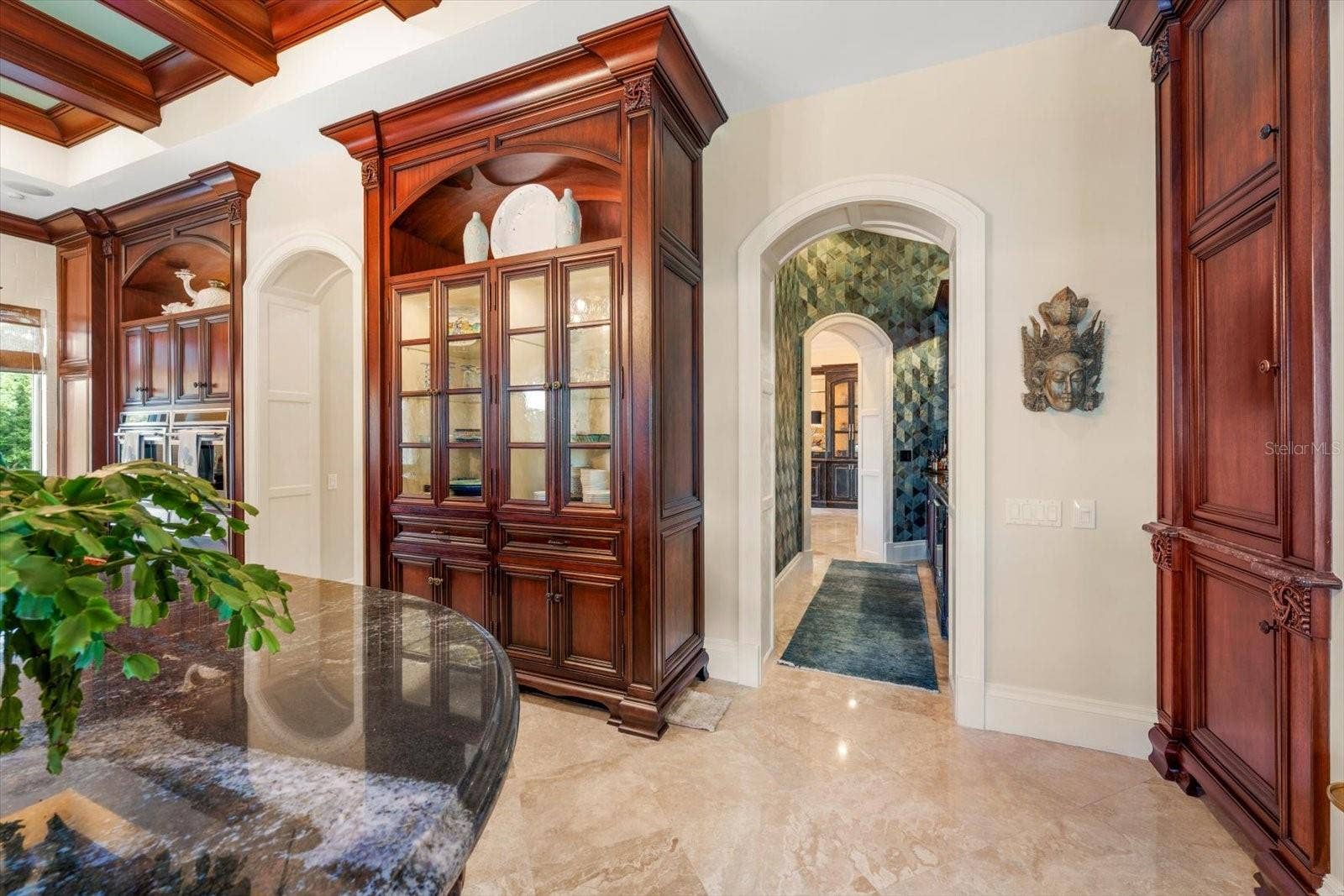 2056 COVE TRACE, Palm Harbor, FL 34685 Arched doorways and a walk-through wet bar connecting to the formal dining room