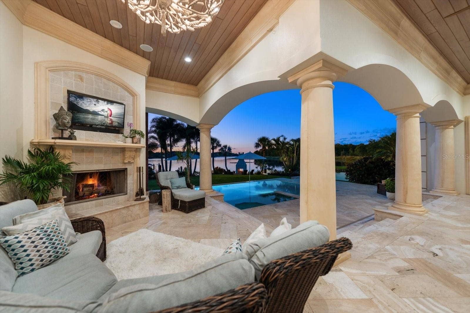 2056 COVE TRACE, Palm Harbor, FL 34685 An expansive covered lanai offers inviting seating, a wood-and-gas fireplace and an Alfresco outdoor kitchen