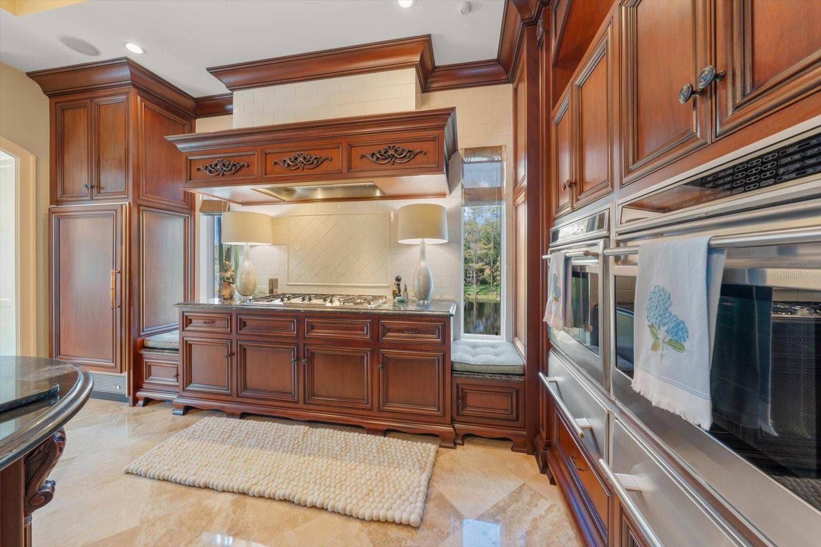 2056 COVE TRACE, Palm Harbor, FL 34685 Thermador 6 burner gas range & side by side Wolf ovens with matching warming drawers. Two Miele dishwashers and a Sub-Zero paneled refrigerator